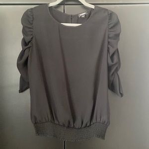 Black dressy top with scrunch sleeves and cinch at bottom